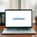 A photo of a computer with the Coinbase logo featured on the screen.
